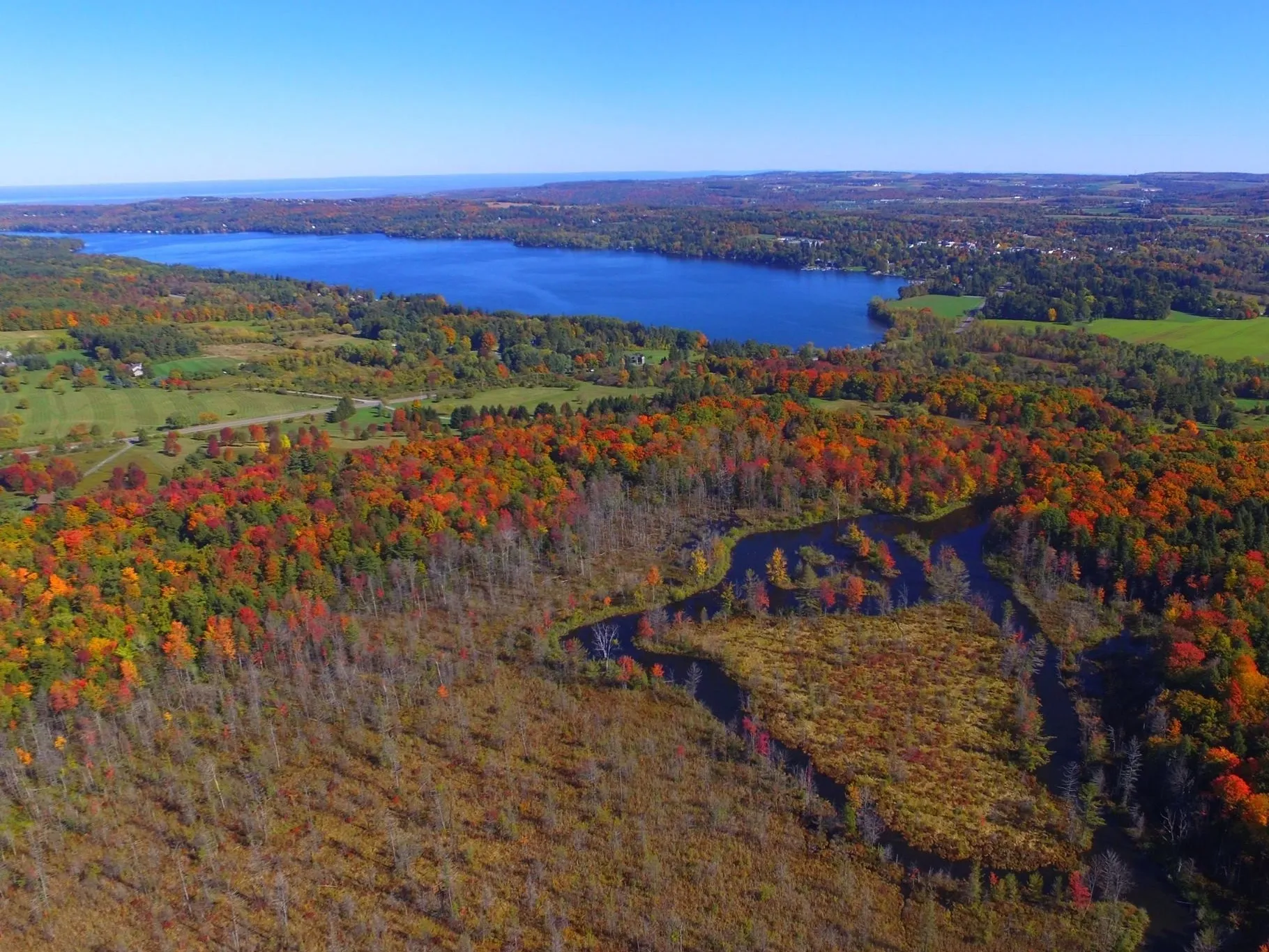 Lake and surrounding wooded countryside in autumn