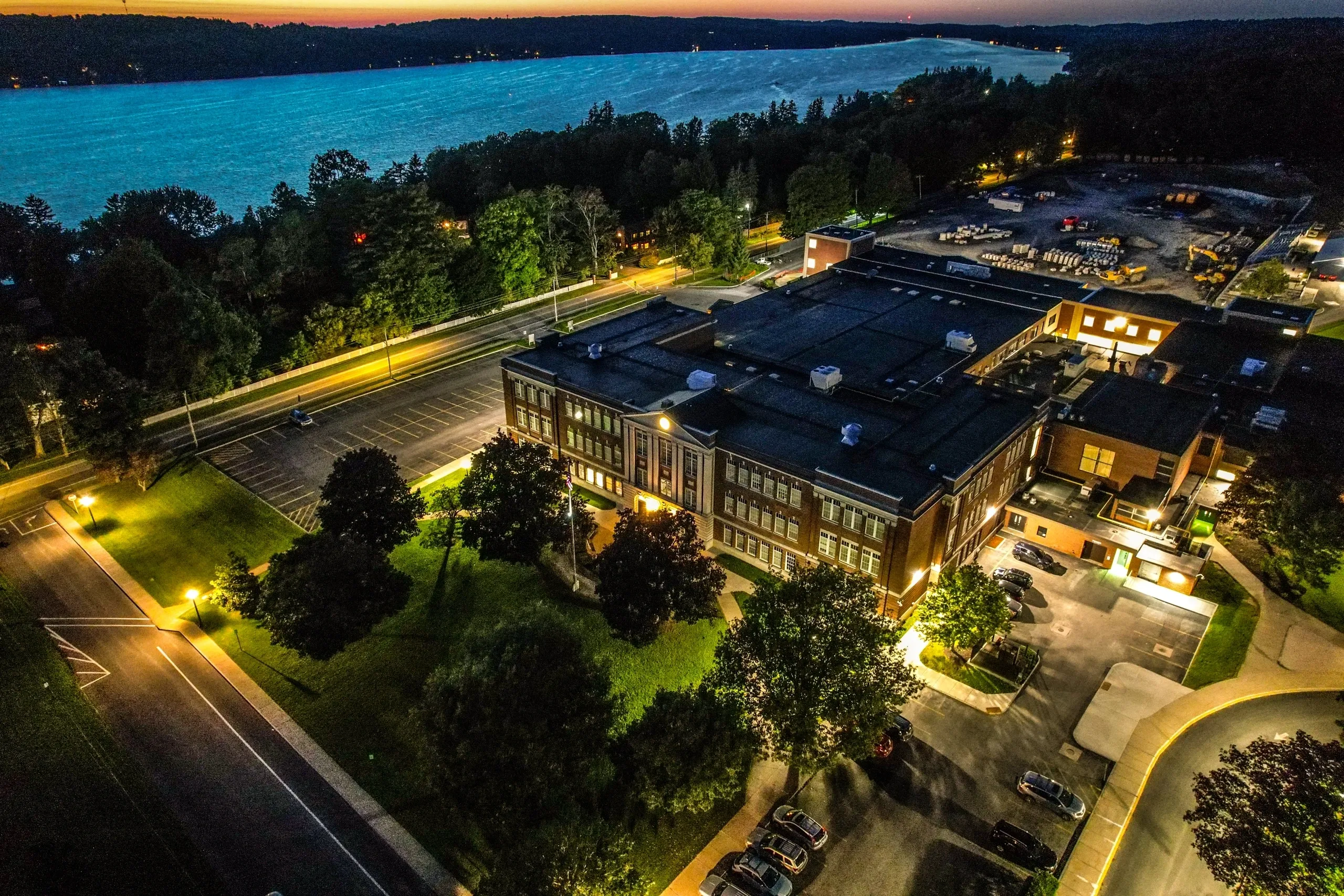 Aerial view of school buildings and athletic fields beside the lake
